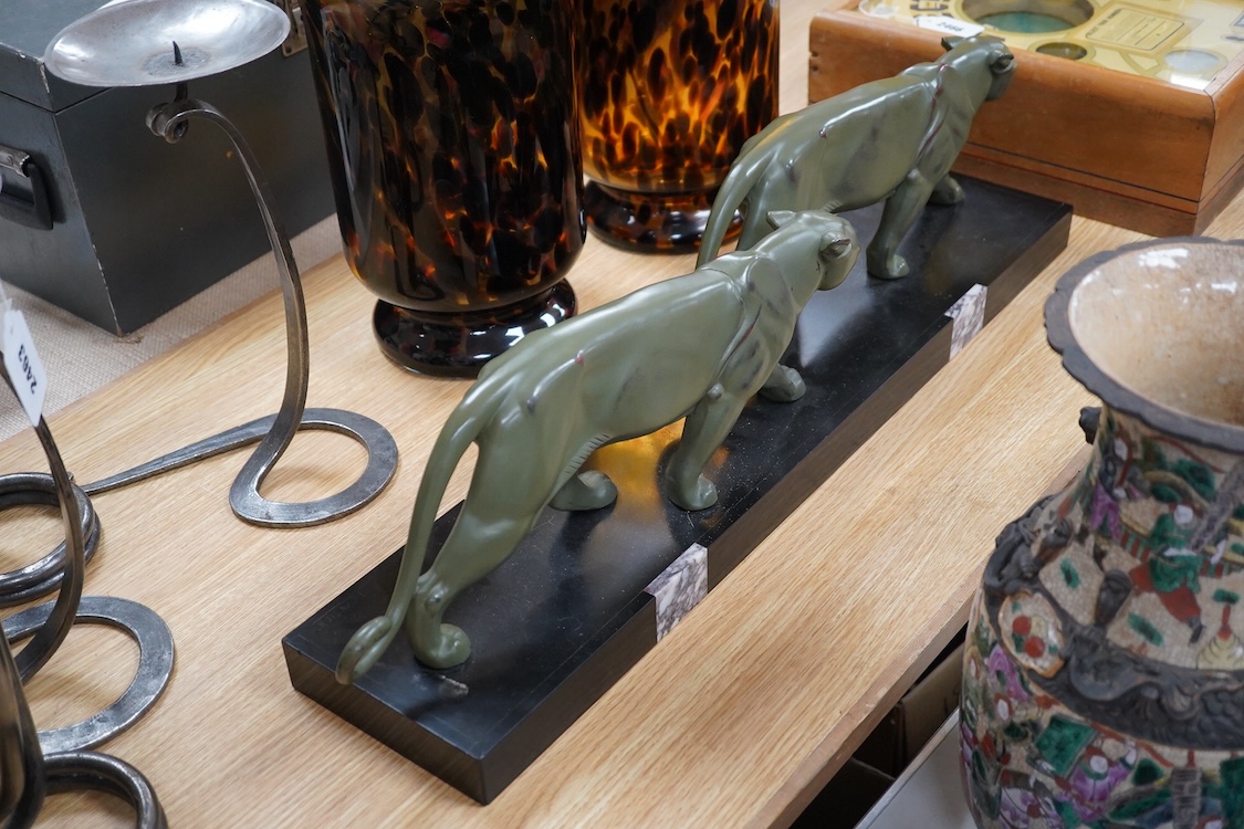 An Art Deco patinated spelter and marble figure of panthers, signed T. Cartier, 70cm